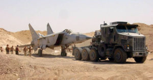 OPERATION IRAQI FREEDOM -- A search team discovers a MiG-25 Foxbat buried beneath the sands in Iraq. Several MiG-25 interceptors and Su-25 ground attack jets have been found buried at Al-Taqqadum air field west of Baghdad. (U.S. Air Force photo by Master Sgt. T. Collins)